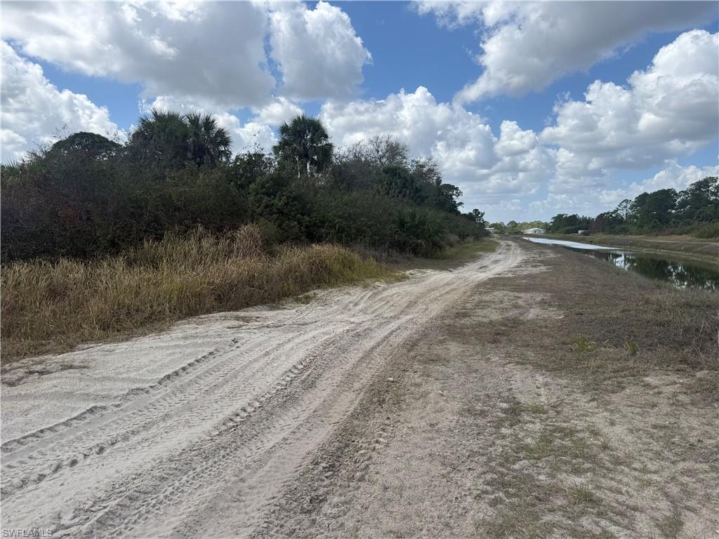 View of dirt / gravel road featuring a water view