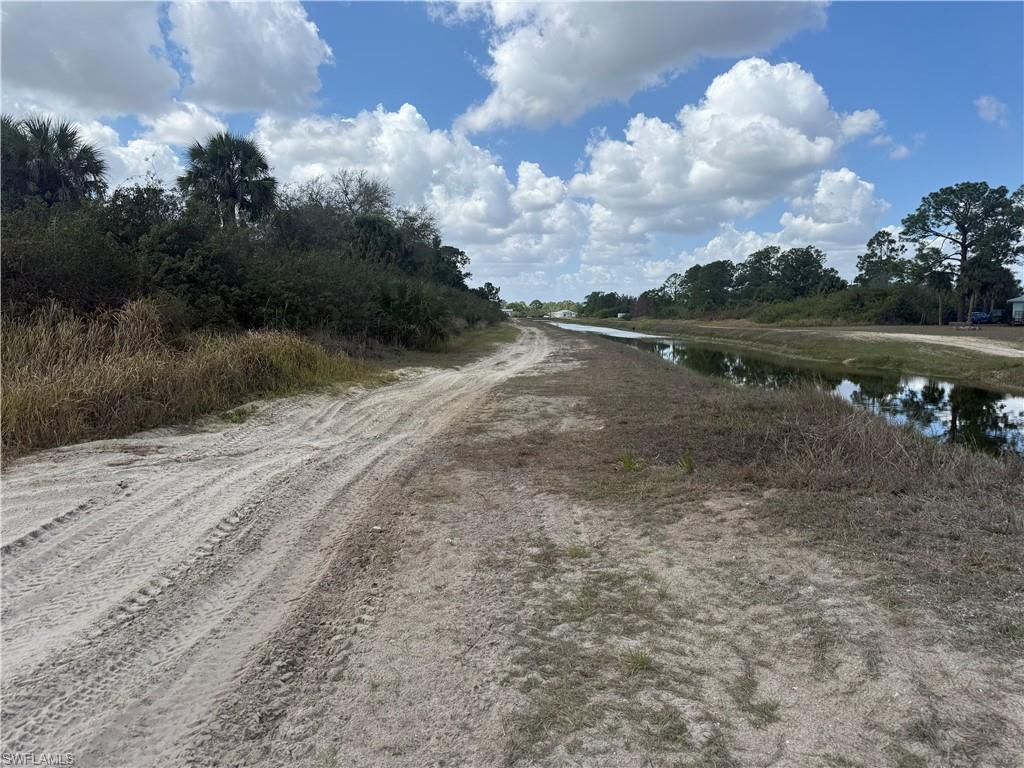 View of dirt / gravel road featuring a water view