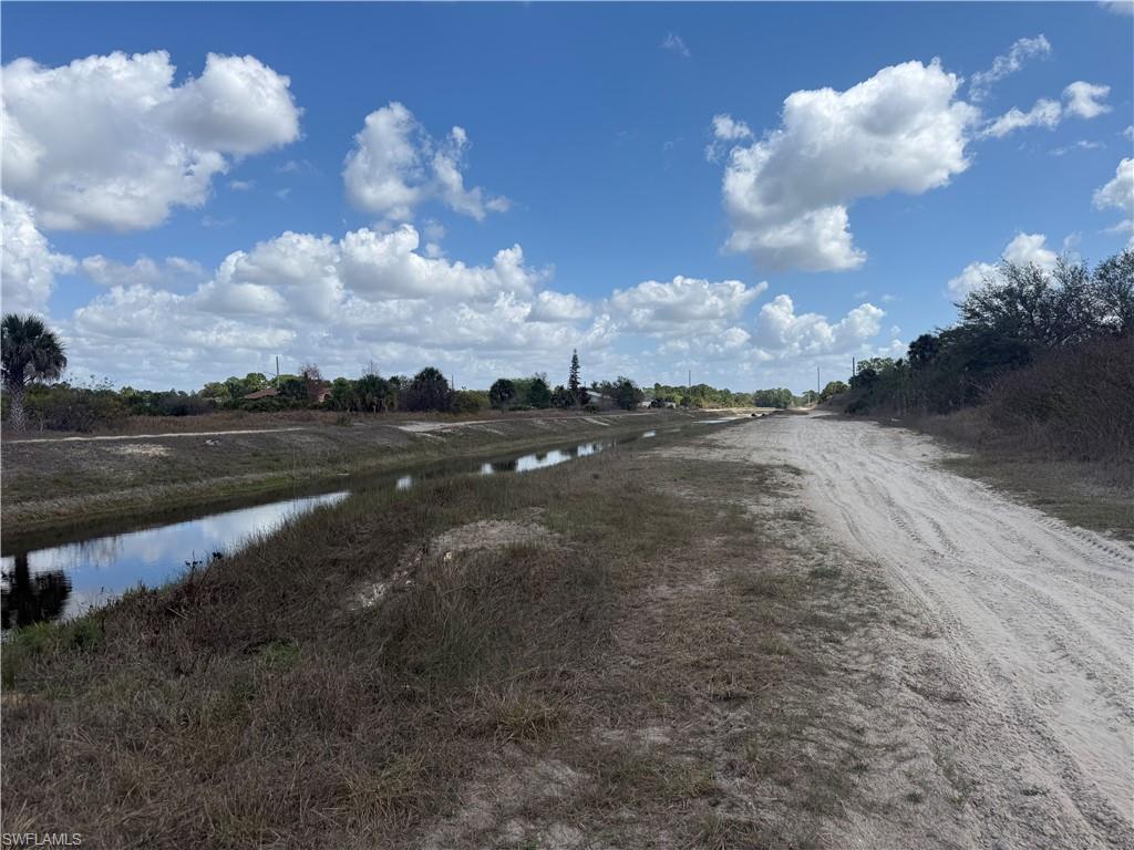 View of dirt / gravel road featuring a water view