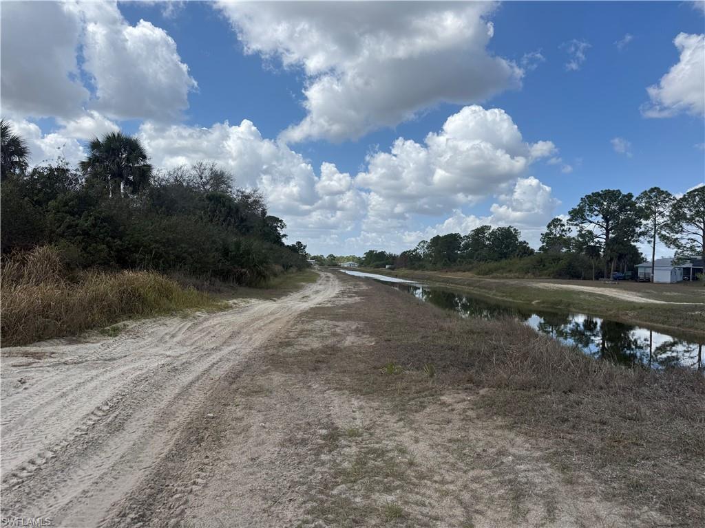 View of dirt / gravel road featuring a water view