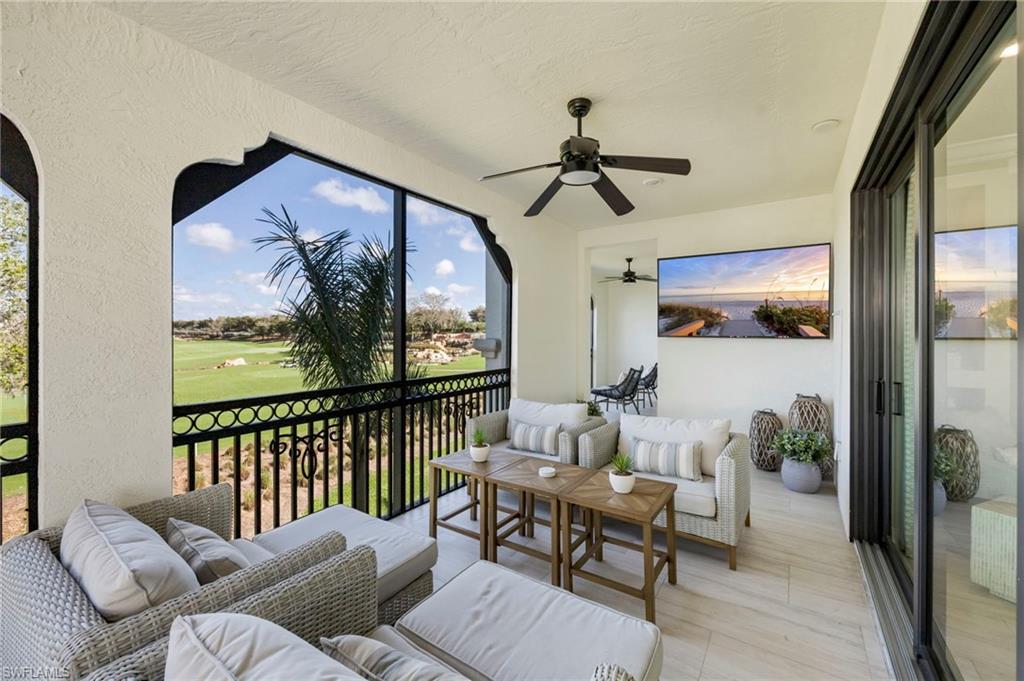 Sunroom with outdoor seating, a balcony, and ceiling fan