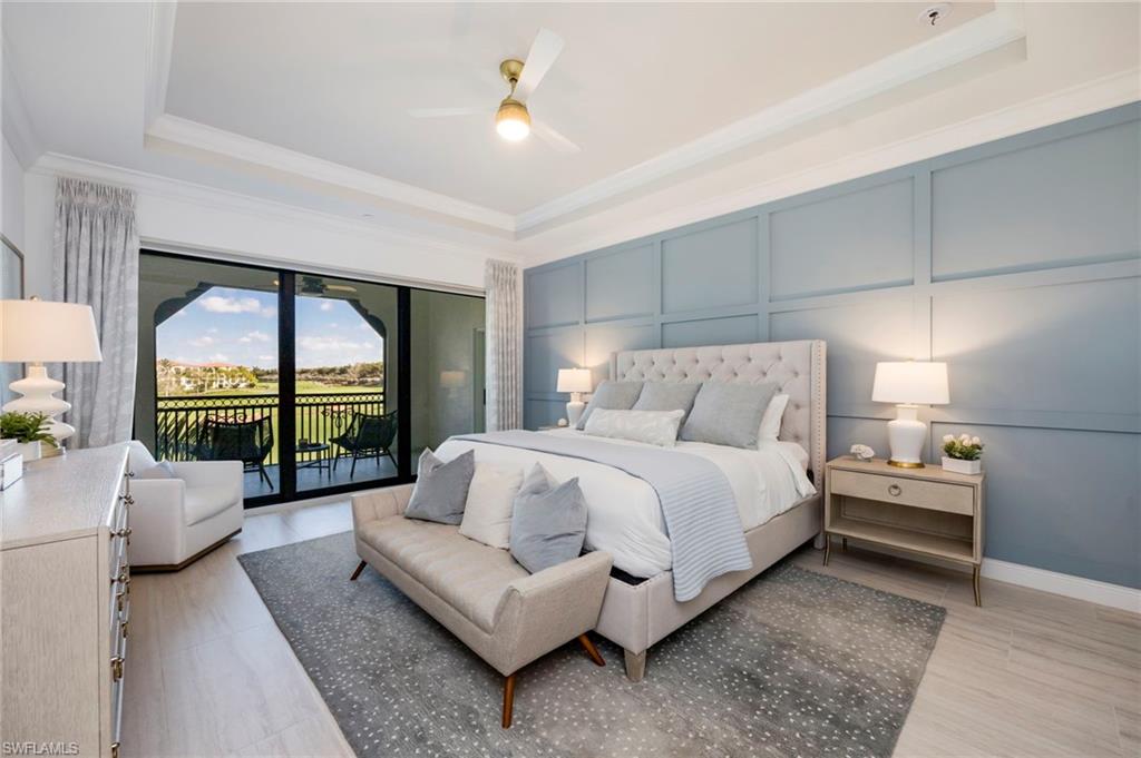 Bedroom featuring a decorative wall, access to outside, ceiling fan, a raised ceiling, and ornamental molding