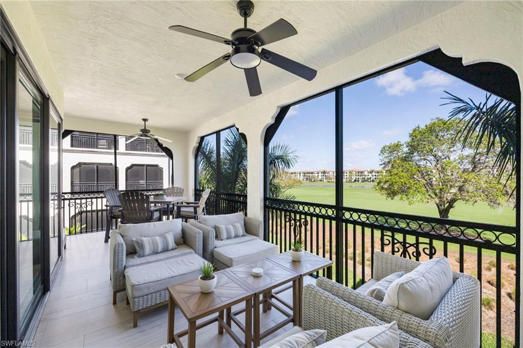 Sunroom with golf course view, a ceiling fan, and an outdoor living / dining area