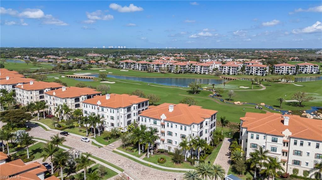 Drone / aerial view of apartment complex and a local golf course