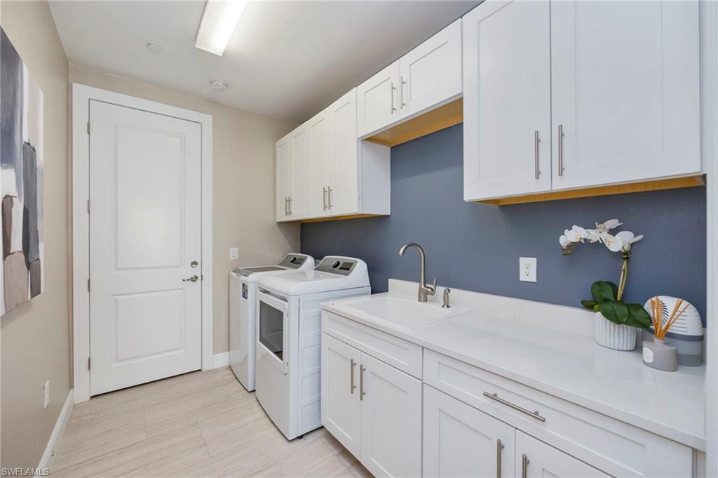 Laundry area featuring cabinet space and independent washer and dryer
