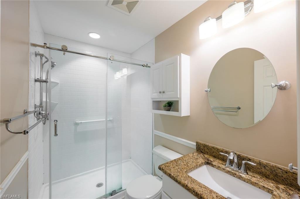 Bathroom featuring vanity and a shower stall