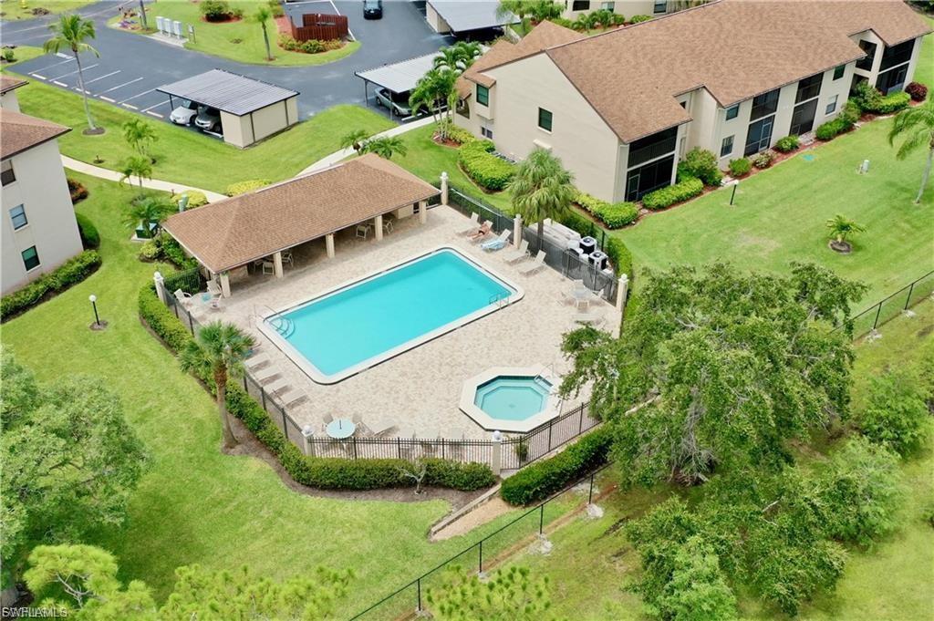 Community pool featuring a community hot tub and a patio