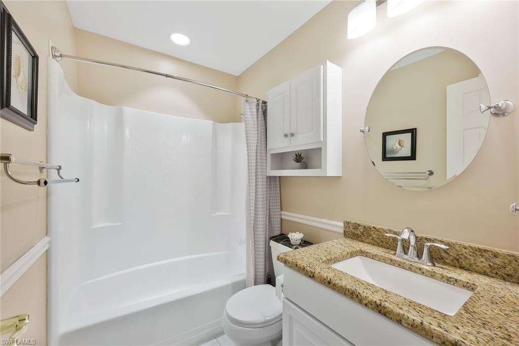 Full bath featuring vanity and shower / bath combo