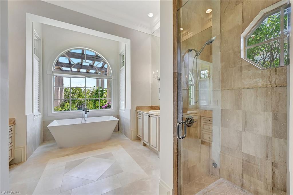 1 of 2 ensuite baths with walk-in shower and soaking tub