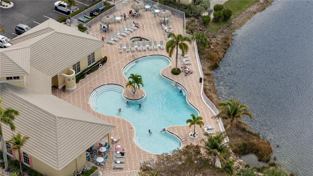 Bird's eye view of a pool and a nearby body of water