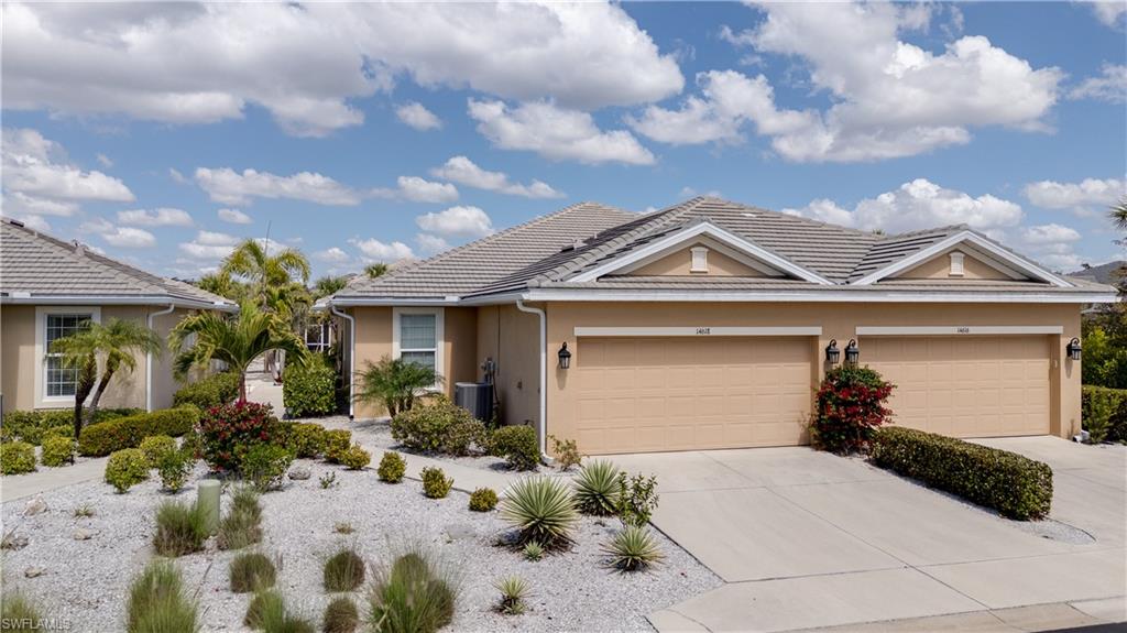 Ranch-style home featuring stucco siding, driveway, and a garage