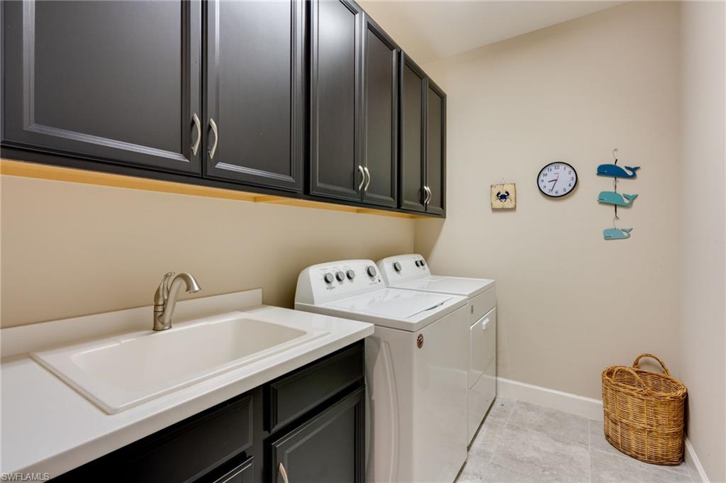 Laundry room featuring washer and dryer and cabinet space