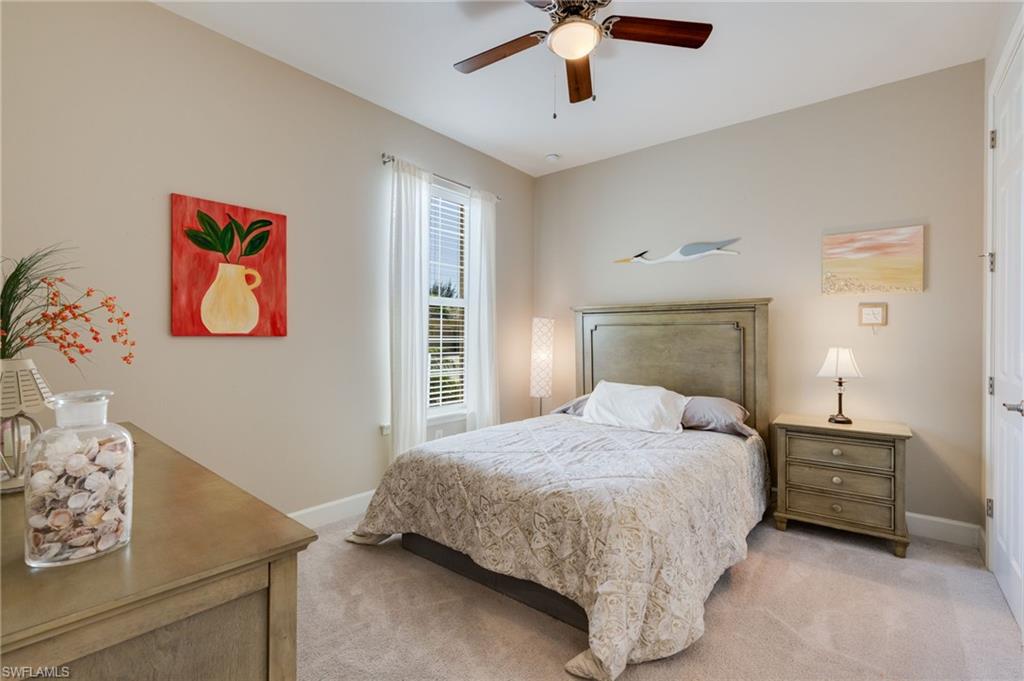 Bedroom featuring a ceiling fan and light carpet