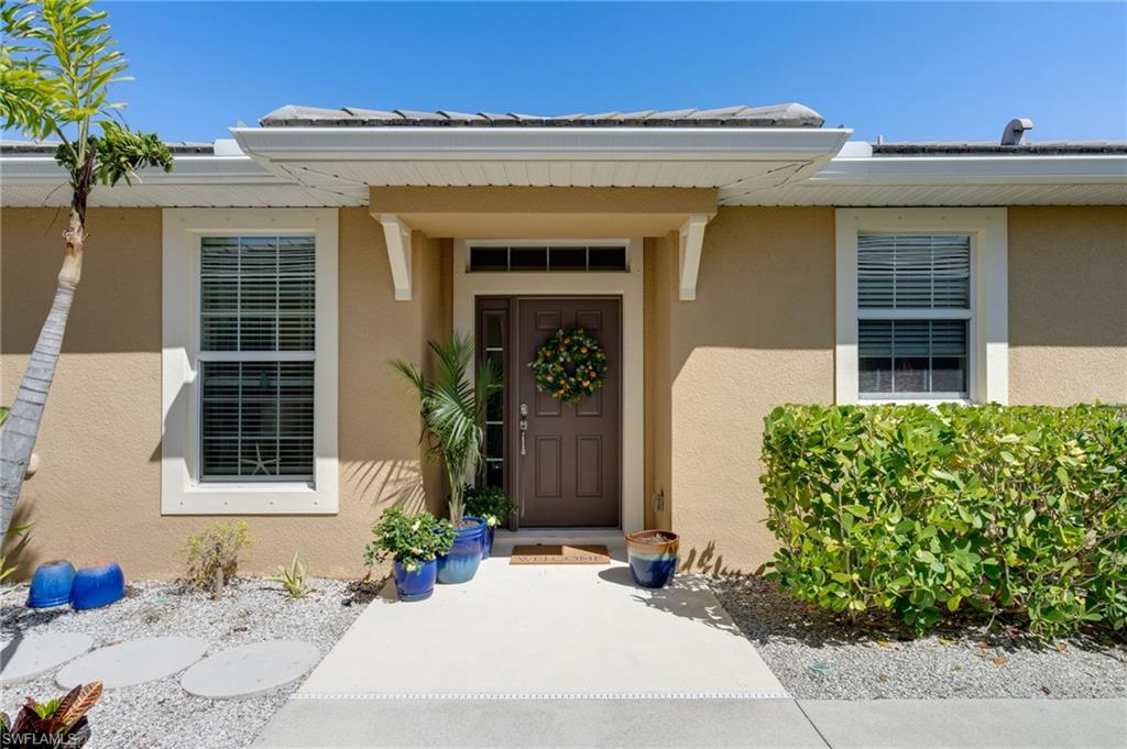 Entrance to property featuring stucco siding