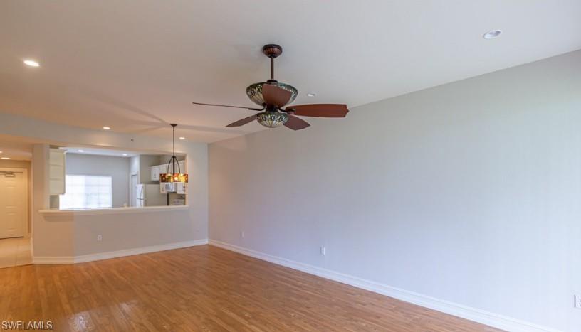Unfurnished living room featuring recessed lighting, baseboards, light wood-style floors, and ceiling fan