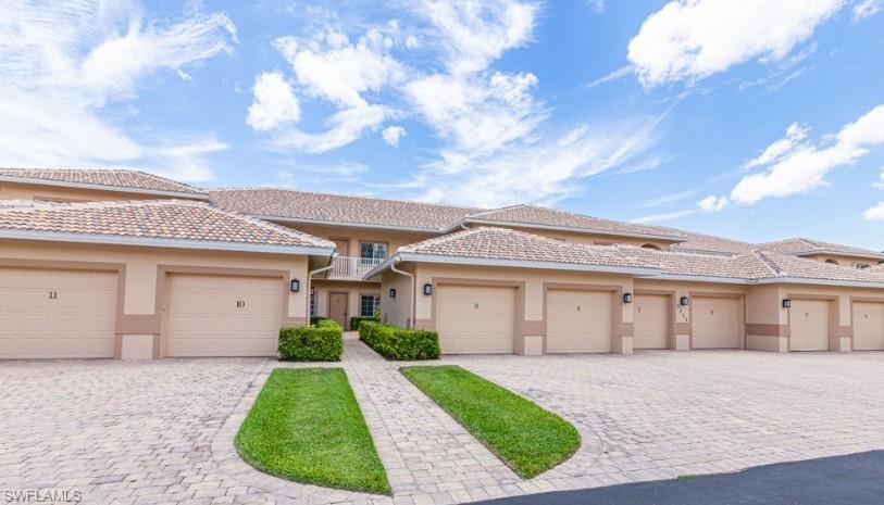 Multi unit property featuring stucco siding, decorative driveway, and a balcony