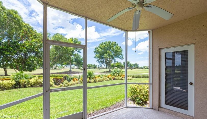Unfurnished sunroom featuring a ceiling fan