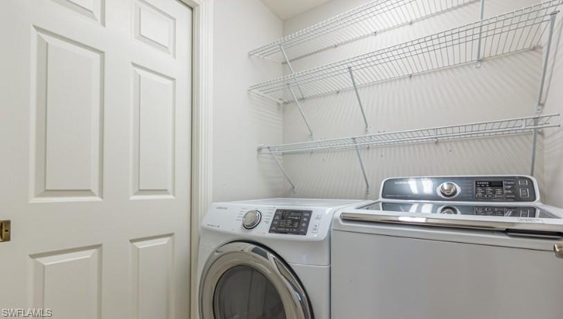 Washroom featuring laundry area and separate washer and dryer
