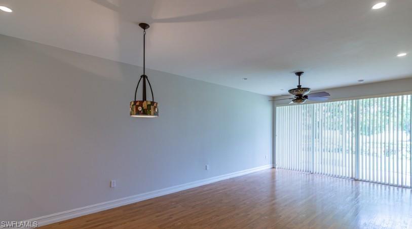 Empty room featuring recessed lighting, wood finished floors, baseboards, and ceiling fan