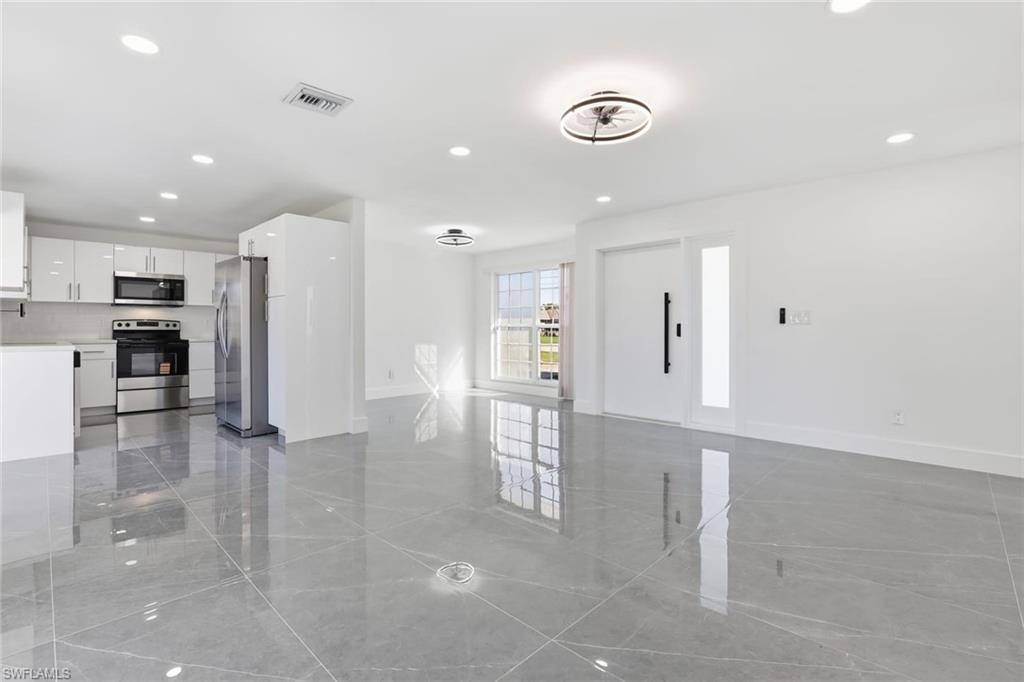 Unfurnished living room featuring recessed lighting