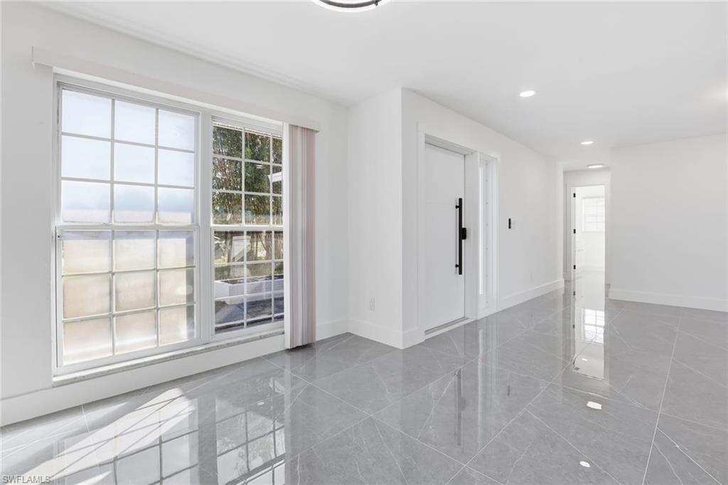 Empty room with baseboards and recessed lighting