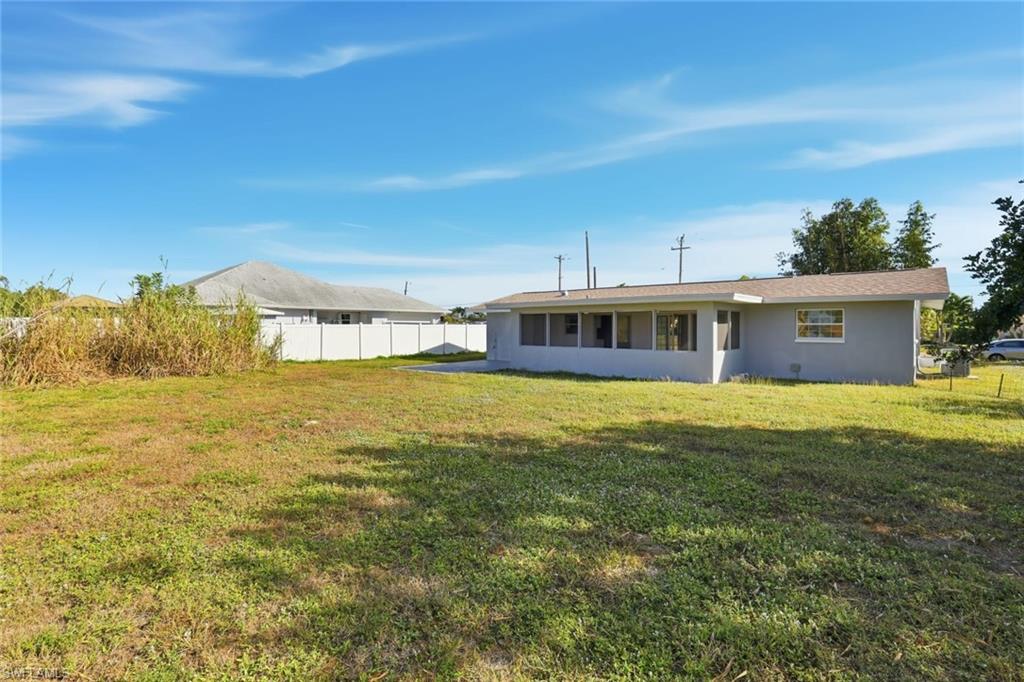 Rear view of property with stucco siding