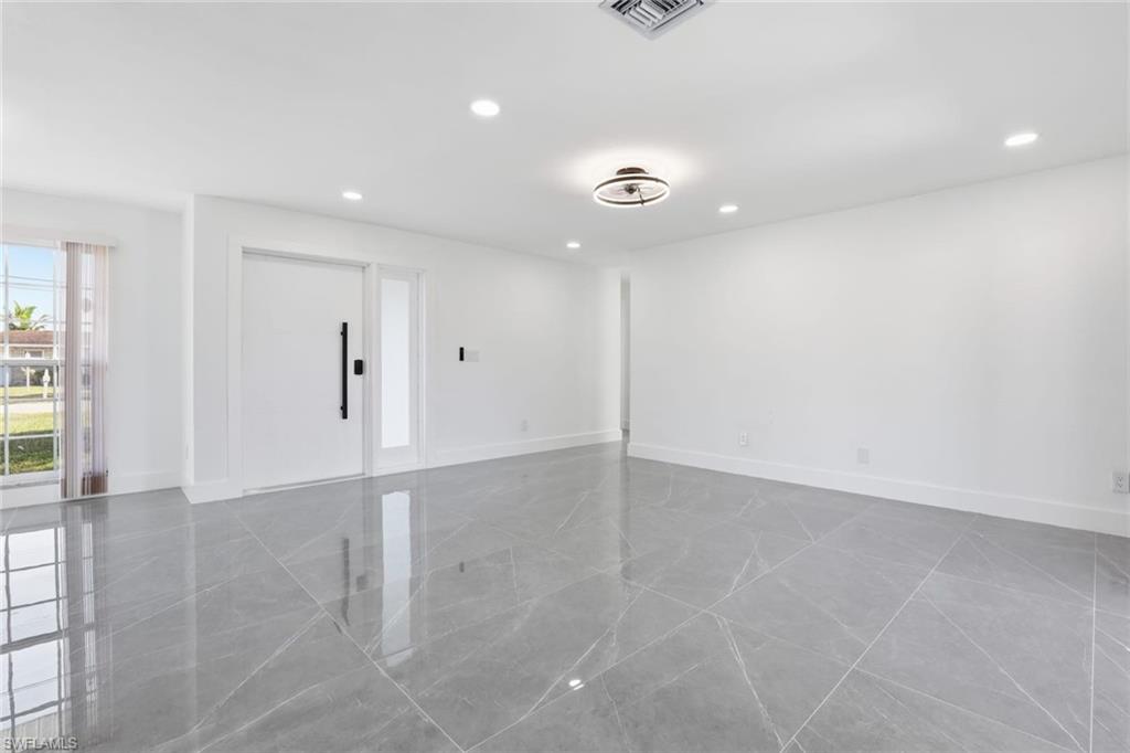 Living room with recessed lighting and baseboards