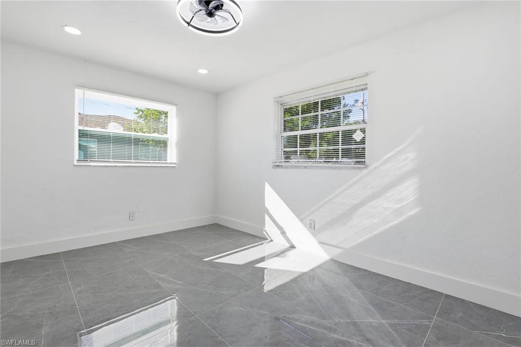 Tiled spare room with baseboards and recessed lighting