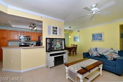 Living area with ornamental molding, light tile patterned flooring, and a ceiling fan