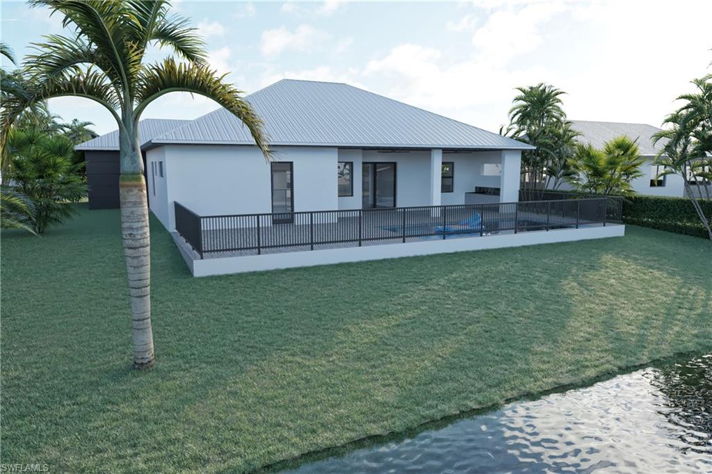 Back of house featuring a metal roof, stucco siding, and a patio