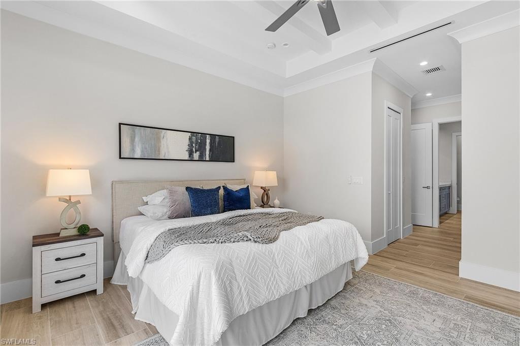 Bedroom featuring light wood finished floors, recessed lighting, ceiling fan, and ornamental molding