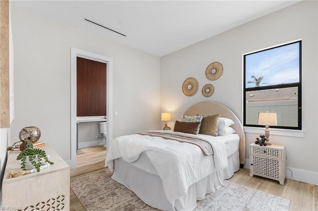 Bedroom with light wood-style flooring and baseboards