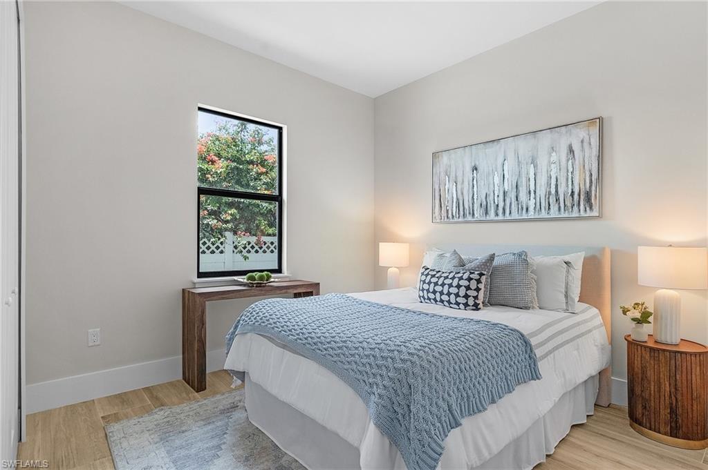 Bedroom featuring light wood-type flooring and baseboards