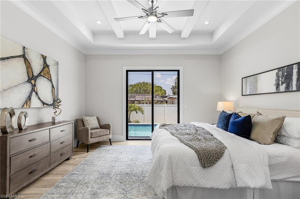 Bedroom featuring access to outside, light wood-style flooring, a ceiling fan, beamed ceiling, and recessed lighting
