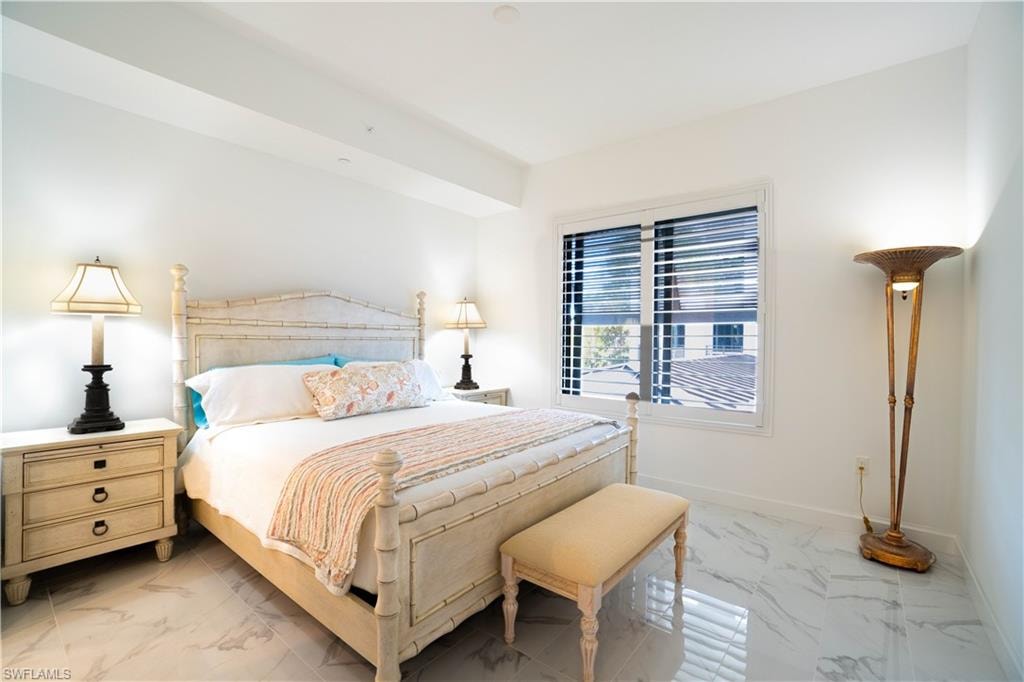 Bedroom with light marble finish floors
