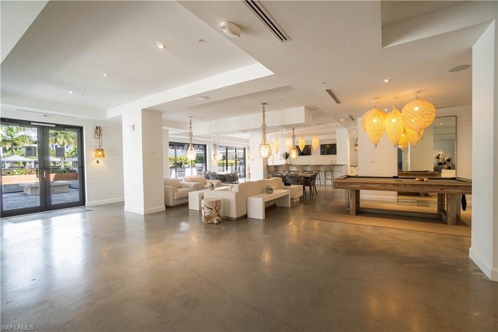 Spacious common area featuring polished concrete flooring and shiplap accent walls