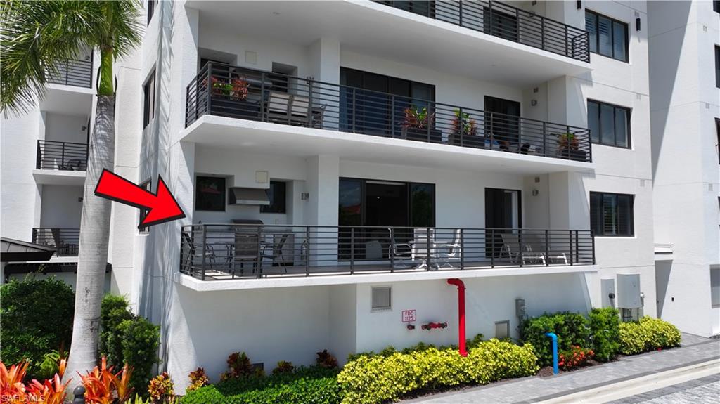 Balcony featuring a built-in outdoor grill, dark horizontal railings, and sliding glass doors