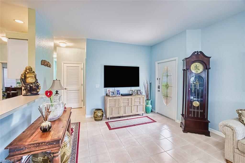 Living area with baseboards and light tile patterned floors
