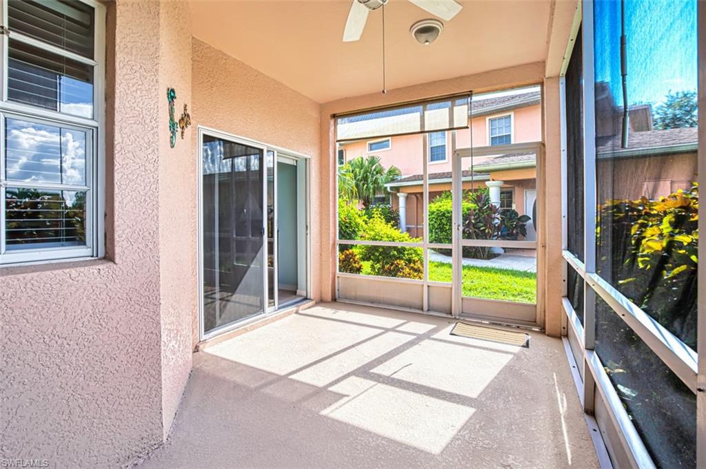 Unfurnished sunroom featuring ceiling fan
