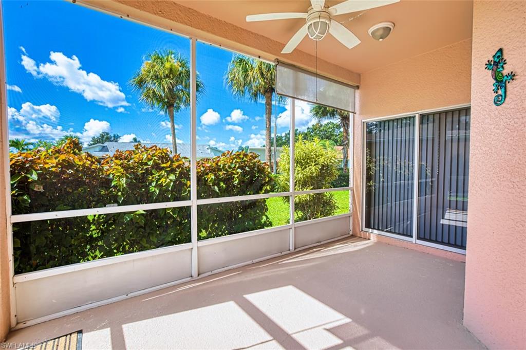 Unfurnished sunroom featuring a ceiling fan