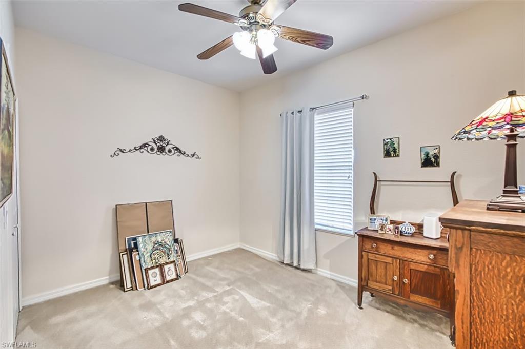 Bedroom featuring light carpet and a ceiling fan