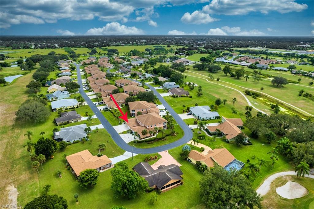 View of property location with a local golf course and nearby suburban area
