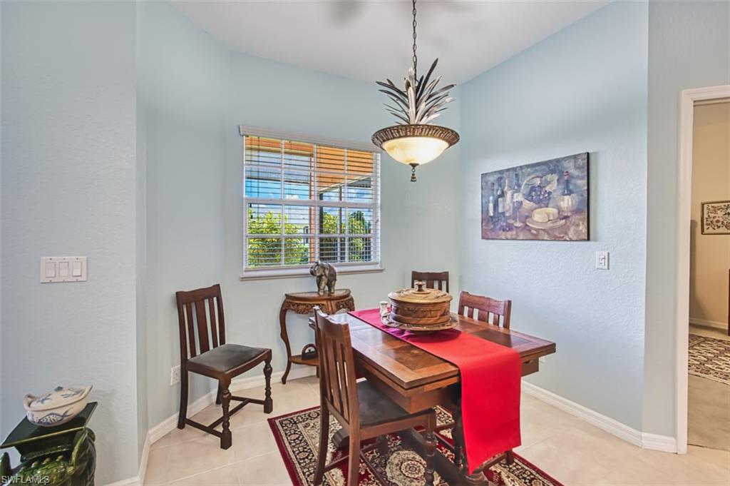 Dining room with a textured wall and light tile patterned flooring
