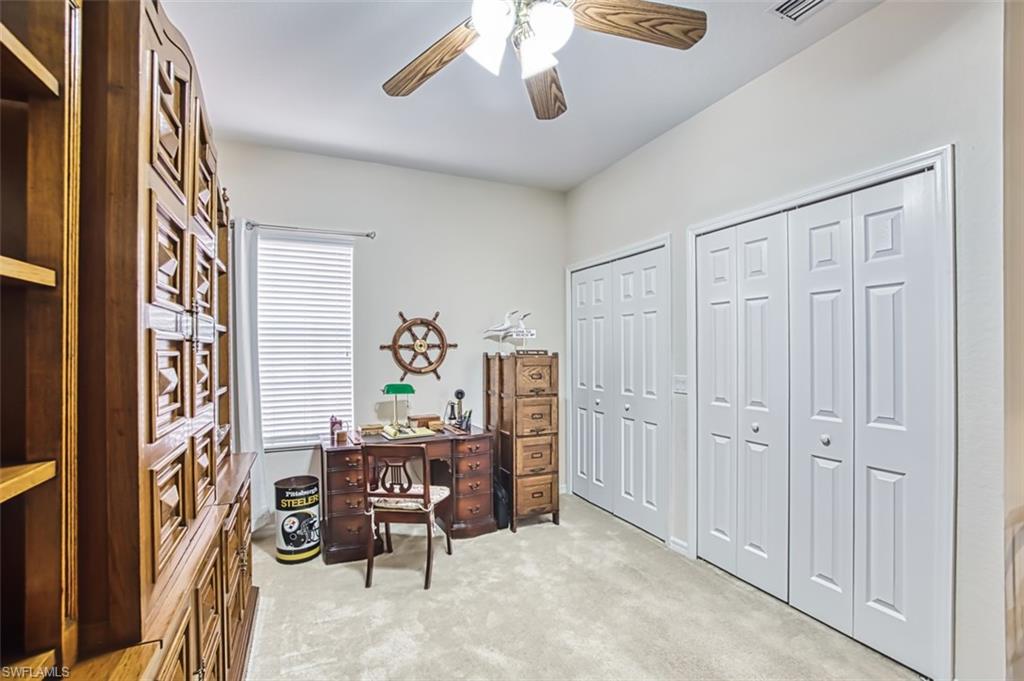 Office space featuring light carpet and ceiling fan
