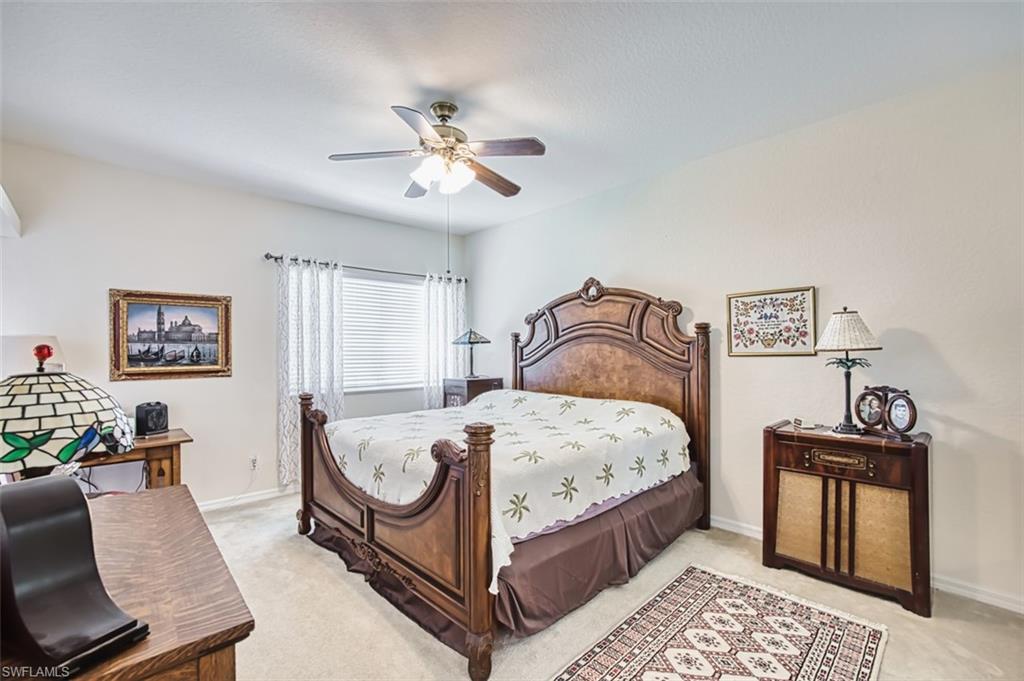 Bedroom featuring a ceiling fan and light carpet