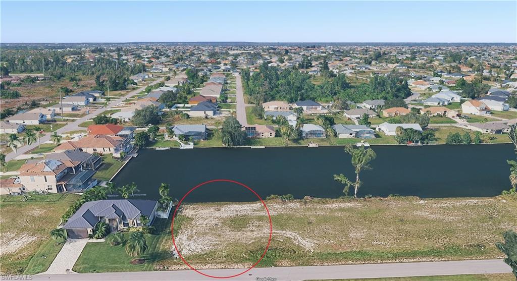 Aerial view of residential area featuring a large body of water