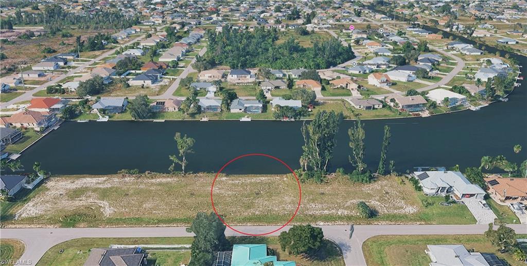 Aerial overview of property's location with nearby suburban area and a large body of water