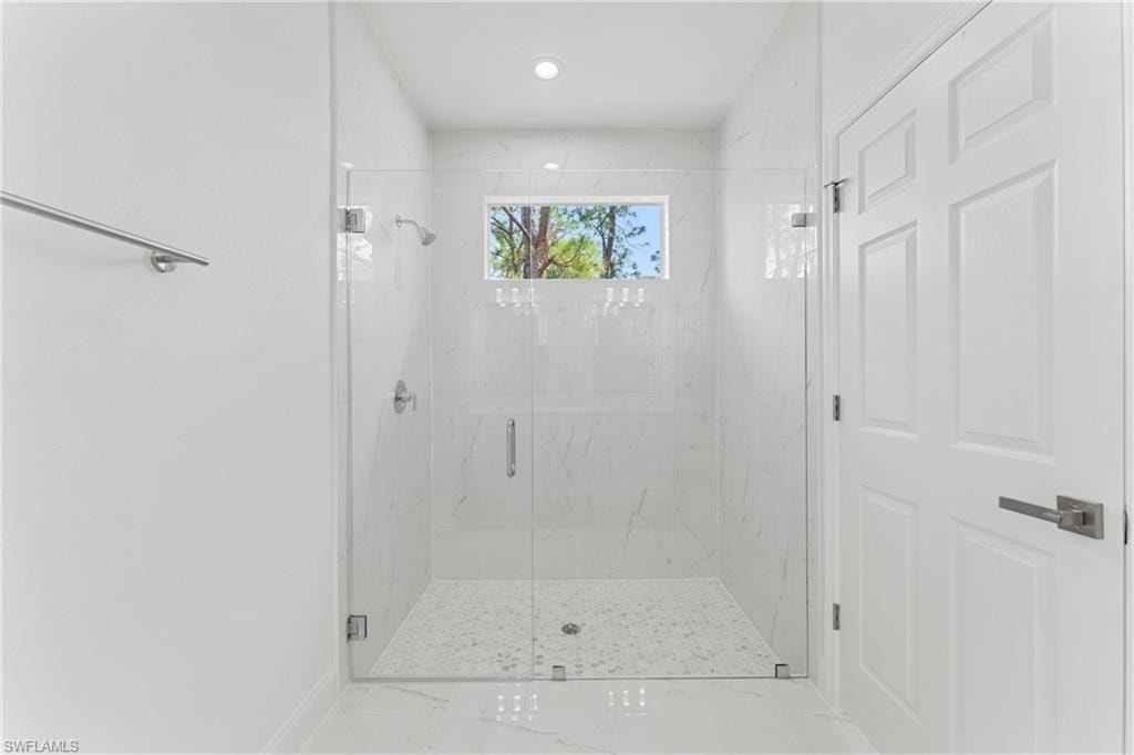 Full bathroom featuring a marble finish shower