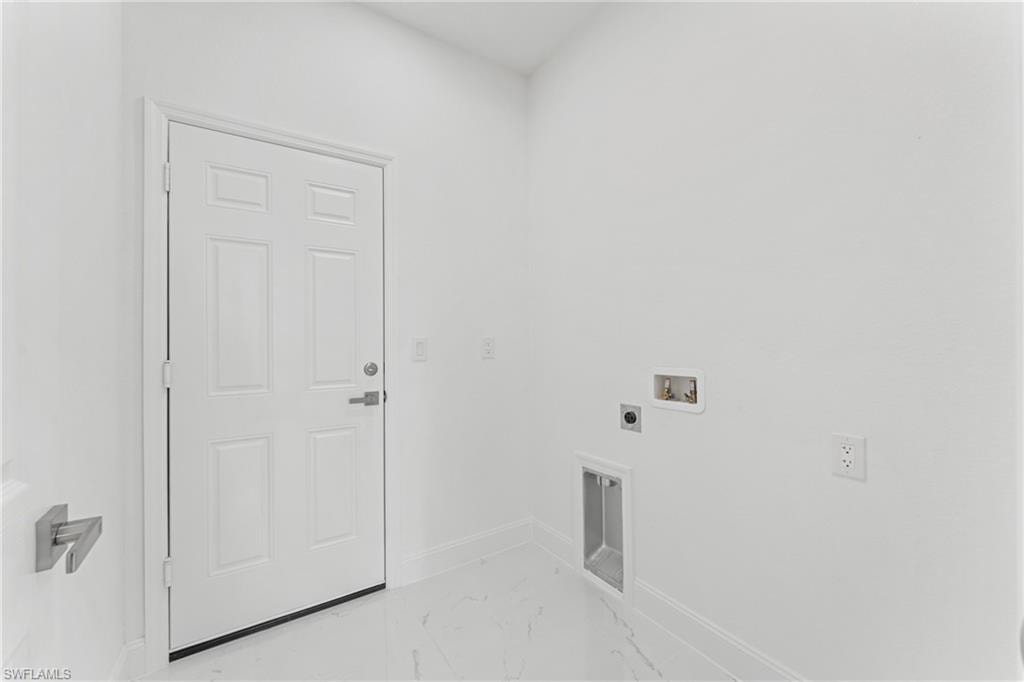 Laundry area with marble finish floor, hookup for a washing machine, electric dryer hookup, laundry area, and baseboards