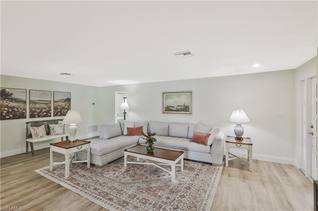 Living area with baseboards and light wood-style flooring
